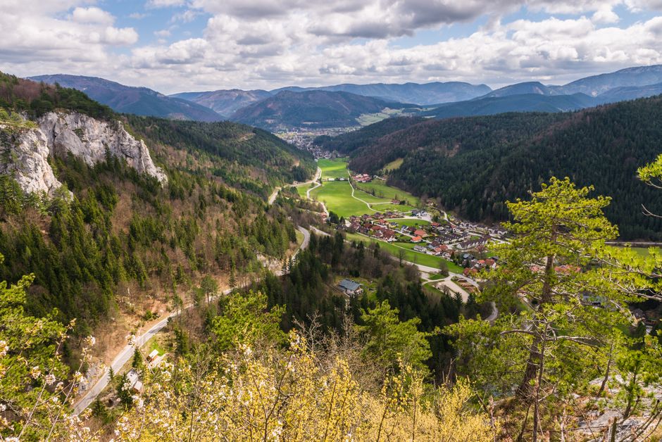 A breathtaking aerial view of a picturesque village nestled in a lush mountain valley.